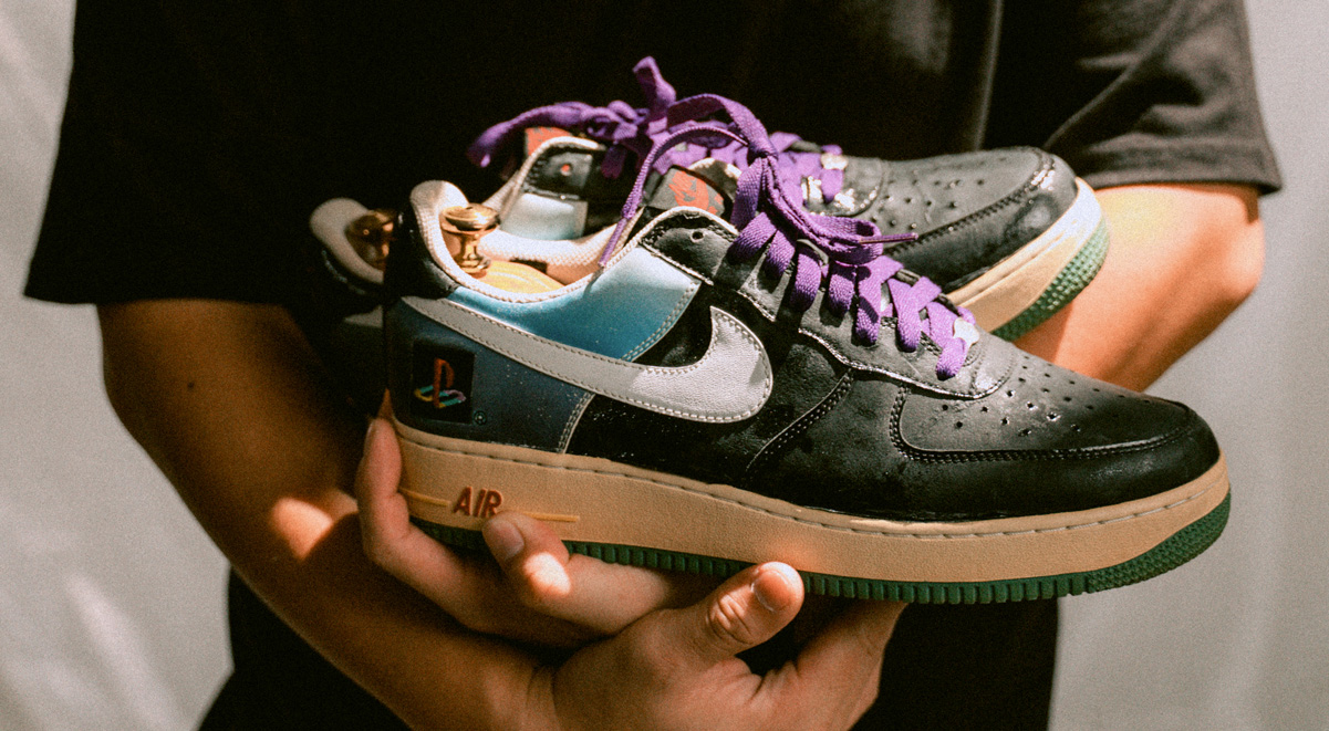 Dexter cradling his most beloved sneaker, the Playstation Air Force 1.