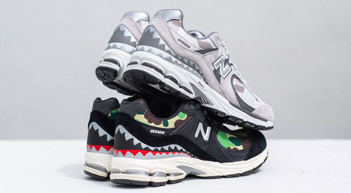 A stack of two colorways of the Bape x New Balance 2002R