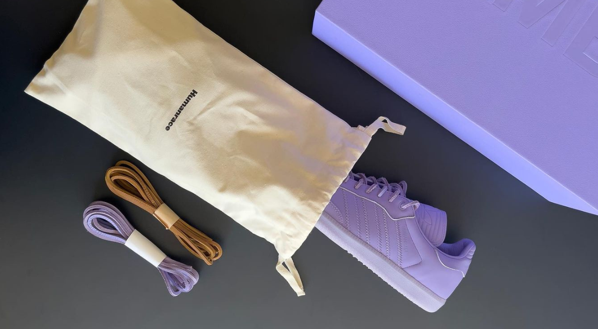 The Pharrell Adidas Humanrace Samba Lilac with its shoe box, dust bag and extra laces. 